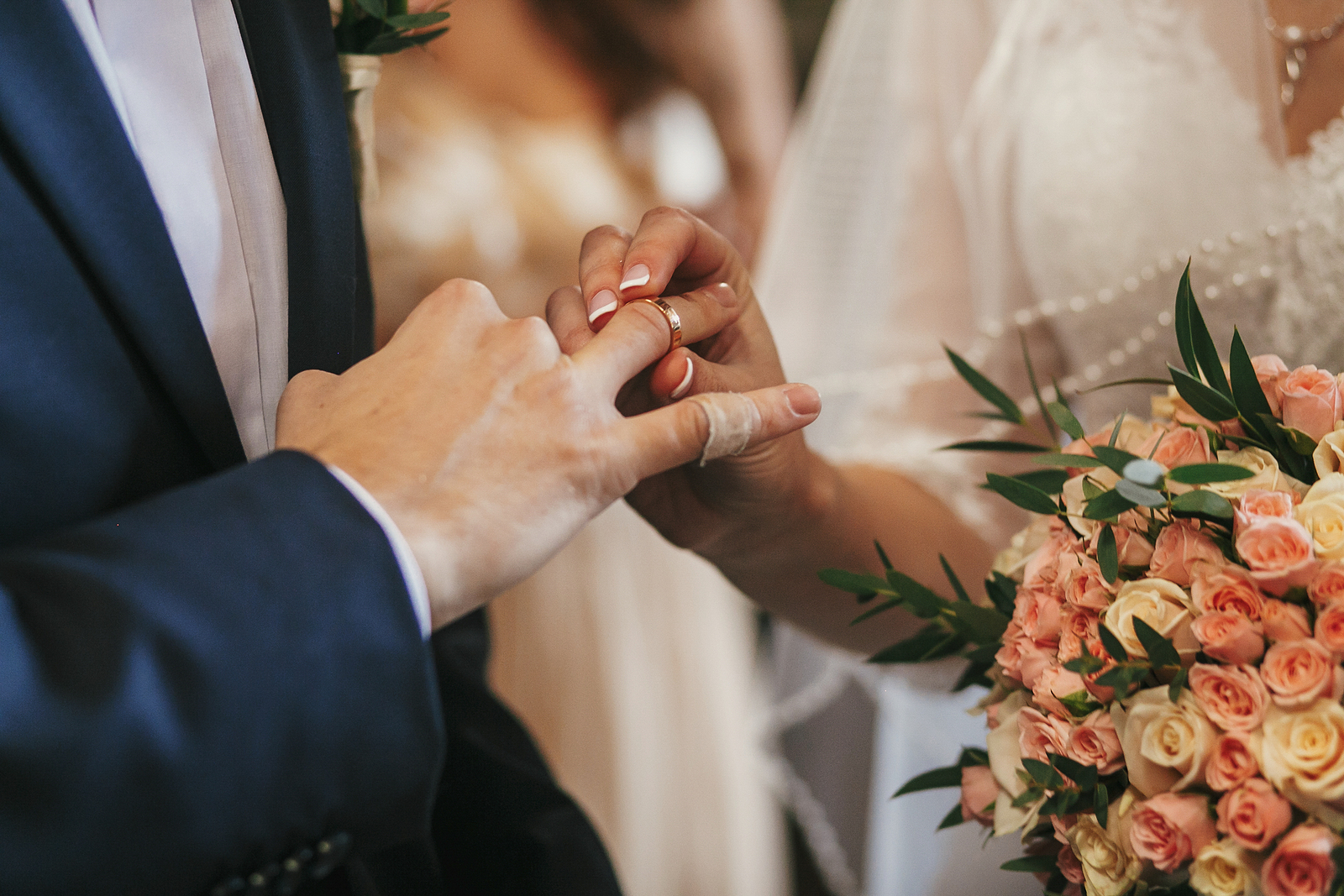 Bride And Groom Hands Exchanging Wedding Rings